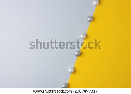 Christmas grey and yellow minimal background with grey ball. Flat lay, copy space