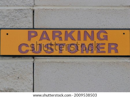 Customer parking sign on the stone wall