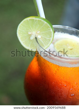 fresh lemon tea in glass with green background
