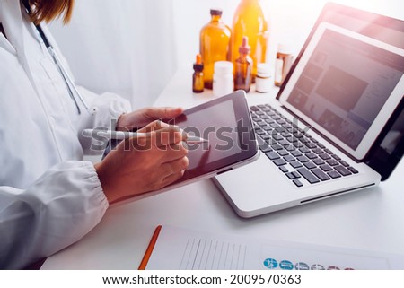 medical technology or medical network. doctor using digital tablet with screen interface.