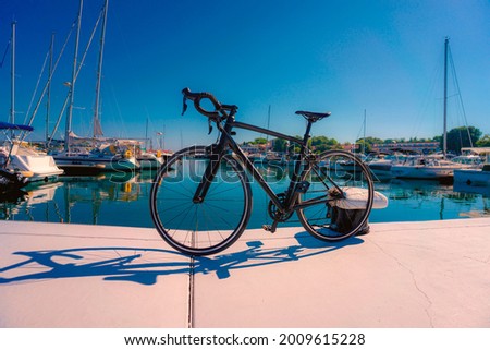 Wide angle close up on a road bike against yacht port in the early morning. Sozopol, Bulgaria.