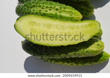 Fresh green cucumbers slice half on white background isolate freshness vegan vegetables
