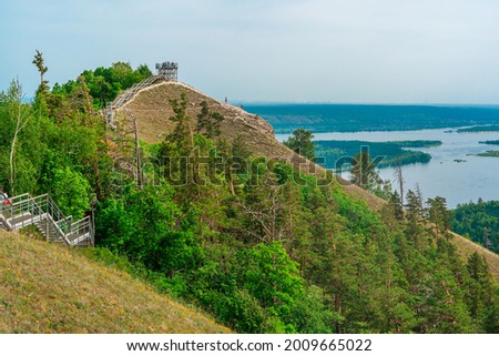 Panorama of mountains with a dense forest and the Volga River on the background, photographed from a height. Nature of Russia