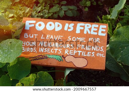Community garden, Food is free sign in vegetable garden                               