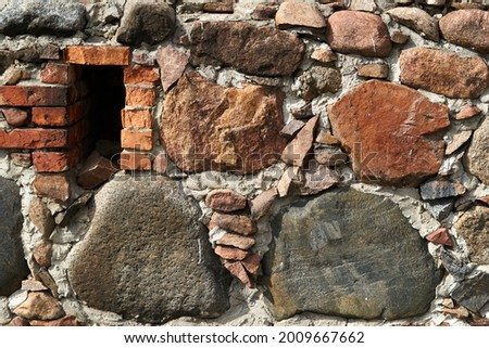 Stone wall background or texture. Large stones bonded with cement mortar. High quality photo