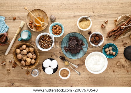 Culinary background with ingredients for baking Thanksgiving or Christmas sweet bake on wooden table