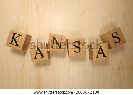 The word Kansas was created from wooden letter cubes. Cities and words. close up.