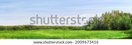 Field and forest on the horizon wide angle scenic view. Extra large panoramic landscape. Royalty-Free Stock Photo #2009673416