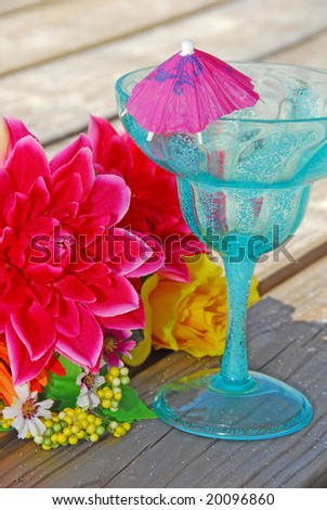 Tropical drink on beach dock by bouquet
