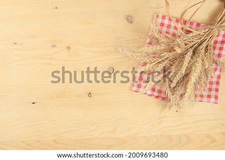 Empty wooden table with sheaf of wheat on old background with place for text, rustic style, harvest concept, advertisement and business card for bakery, store, mock up for design and product showcase
