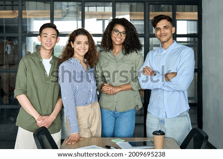 Diverse multiracial happy smiling colleagues international business startup creative team students standing looking at camera in modern office. Ethnicity, diversity, cooperation concept. Portrait Royalty-Free Stock Photo #2009695238