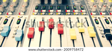 Close-up volume slide button control on sound mixer in studio for sound record control system and audio equipment and music instrument