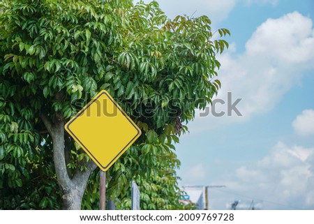 Blank yellow traffic signs color, on the side of the road, rhombus shape, mockup traffic sign