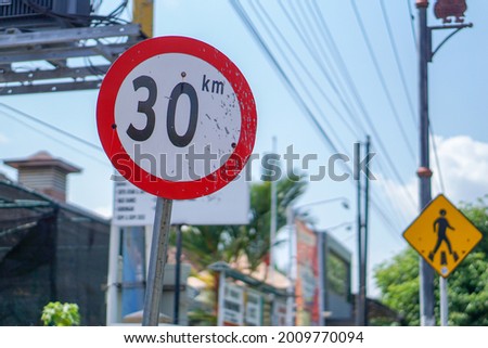 Indonesian red and white circular traffic sign, limiting vehicle speed to 30km per hour