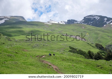 High altitude Bhrigu lake trek on meadows and snow capped mountains