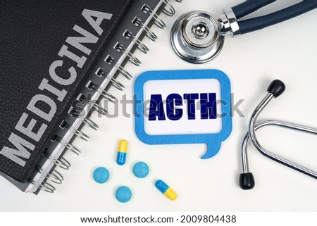 Medicine and health concept. On the table is a stethoscope, a diary and a sign with the inscription - ACTH