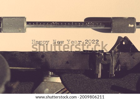 Typewriter with the phrase, Happy New Year 2022