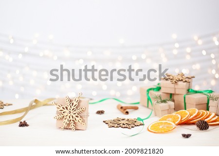 Eco friendly packaging gifts in craft paper on wooden table. Zero waste Christmas holiday concept. Close up, copy space.