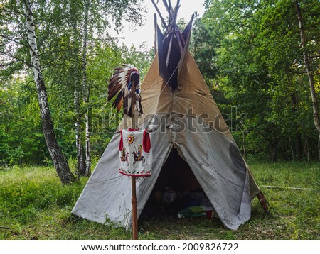 Forest home of the Indians. Wigwam indian teepee. Royalty-Free Stock Photo #2009826722
