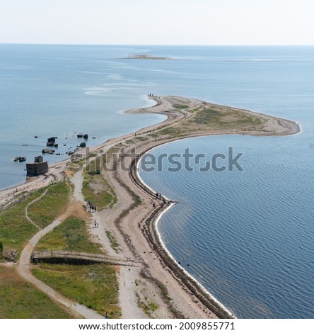 Sõrvesäär peninsula view from the top Sõrvesäär lighthouse. View over the baltic sea. Nice sandy Estonian coast line. Some soviet army area ruines on the left side. Sunny summer day and calm waters