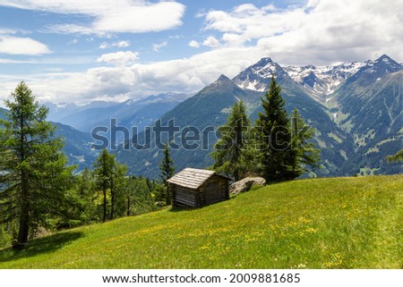 an old mountain hut in the middle of an beautiful grassland at the national park hohe tauern next to Matrei, Osttirol Austria  Royalty-Free Stock Photo #2009881685