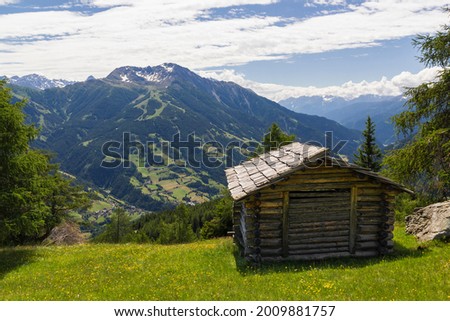 an old mountain hut in the middle of an beautiful grassland at the national park hohe tauern next to Matrei, Osttirol Austria  Royalty-Free Stock Photo #2009881757