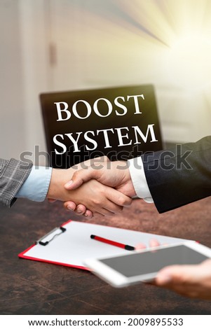 Text sign showing Boost System. Internet Concept Rejuvenate Upgrade Strengthen Be Healthier Holistic approach Two Professional Well-Dressed Corporate Businessmen Handshake Indoors