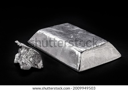 manganese nugget and ingot, metal used in the manufacture of metal alloys, in the production of steel, or in copper, zinc, aluminum, tin and lead alloys Royalty-Free Stock Photo #2009949503