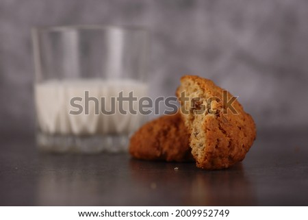 breakfast concept - oatmeal cookies and a glass of milk isolated on gray background. Image contains copy space