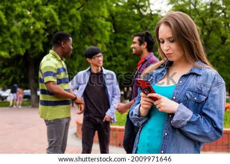 Lovely girl taking selfie during meeting with male friends