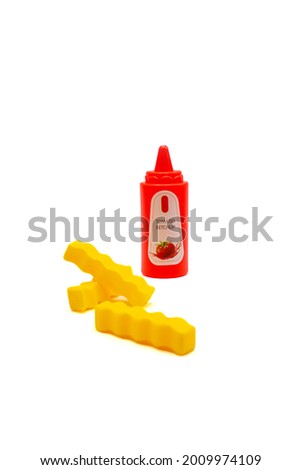 Isolated photo of a toy plastic French fries and ketchup