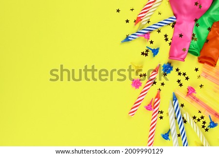 Festive background with birthday decor. Candles, balloons and confetti