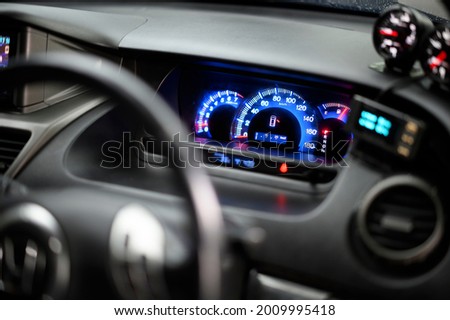 Close-up of car dashboard in raining day.