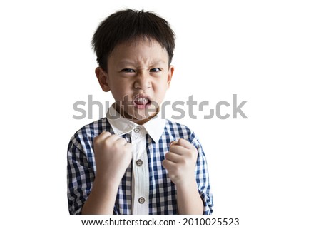 Angry little child clenched fist,show dissatisfied expression on face,feeling upset annoyed,bad behavior,Temperamental kid boy with Attention Deficit Hyperactivity Disorder,irritability,full of anger Royalty-Free Stock Photo #2010025523