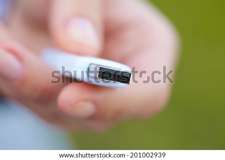 hand holding black USB data storage