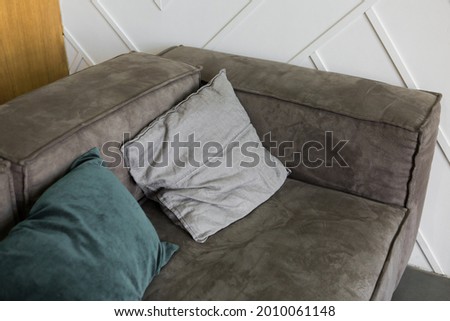 Gray sofa with pillows in the apartment