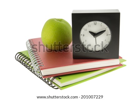 Alarm clock ,notebook memo and apple  isolated on white background