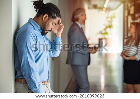 Male Worker having headache. Dark-haired office worker having headache after been fired from work for no reason. Stressed employee intern suffering from gender discrimination or unfair criticism. Royalty-Free Stock Photo #2010099023