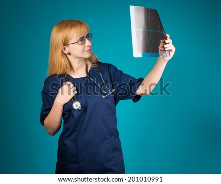 Female doctor looking at the x-ray picture. 