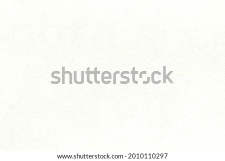 Light uniform texture of a smooth sheet of paper. The surface of the cardboard with small inclusions.