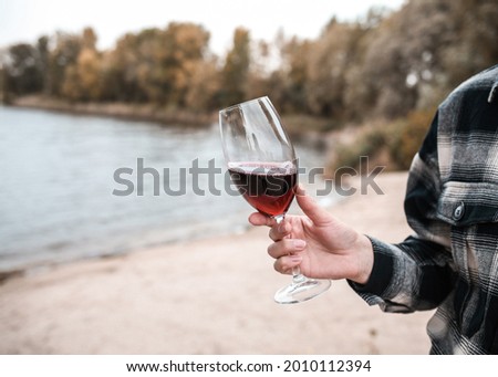 Young woman with glass of wine. Picnic. 