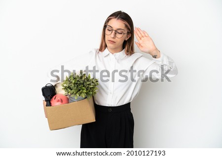 Young caucasian woman moving in new home among boxes isolated on white background making stop gesture and disappointed