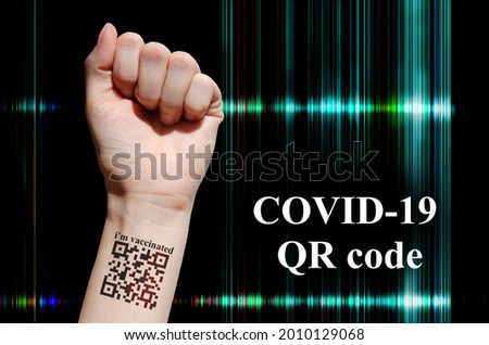Female hand with virtual vaccination QR code tattoo. Abstract futuristic background. Covid -19 QR code authentication  medical concept. 