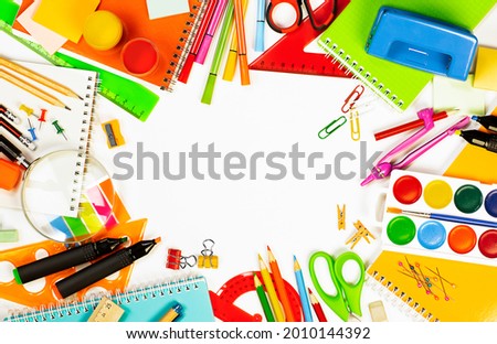 school supplies on a light background are laid out in a circle