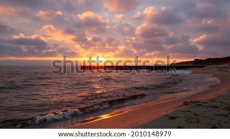 Sunrise on the beach, colorful clouds create beautiful effect