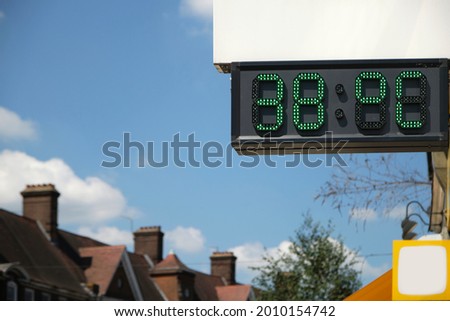 
A digital thermometer in London showing the temperatures during the UK heat wave. It reads 38  °C (degree Celsius). Royalty-Free Stock Photo #2010154742