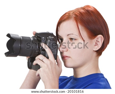 Portrait of a redheaded girl photographer isolated against a white background.