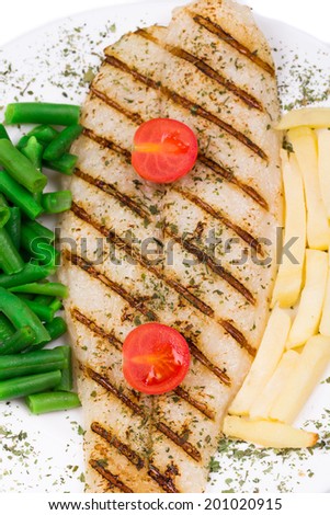 Fresh grilled fillet of pangasius. Isolated on a white background.