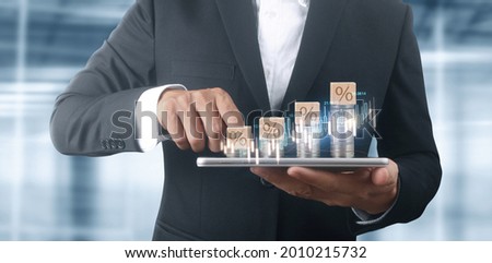 Coin and wealth concept. Loads of money on glass representing smartphone
