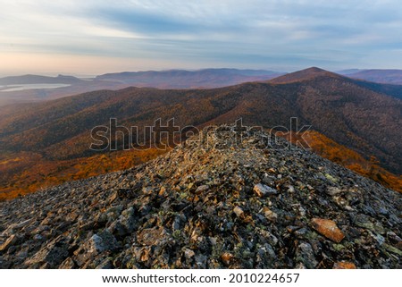 Sikhote-Alin Biosphere Reserve. The rocky slope of Mount Lysaya. See from above. Rocky ridge of a high mountain during a bright sunrise.